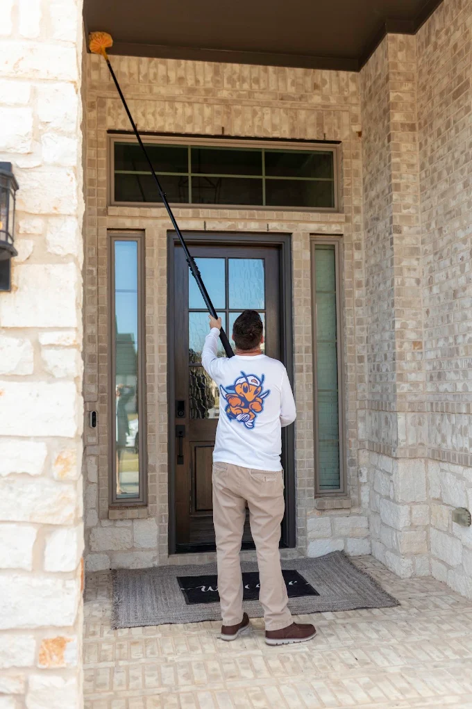 Slade Pest Solutions technician providing pest control service at a Fort Worth, Texas property