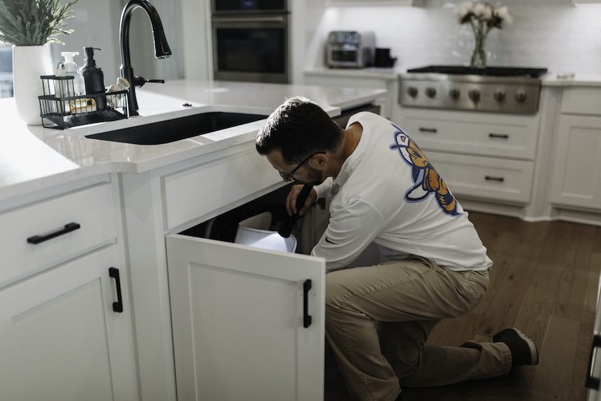 Slade Pest Solutions technician providing pest control service in a Roanoke, Texas home